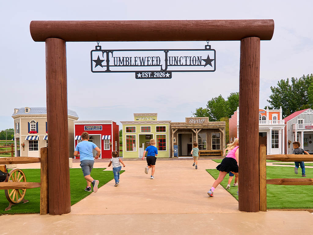 Kids running through Tumbleweed Junction, the western tiny town